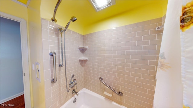 bathroom featuring wood-type flooring and shower / bath combo with shower curtain