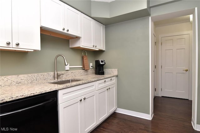 kitchen with dark hardwood / wood-style flooring, light stone counters, sink, black dishwasher, and white cabinetry