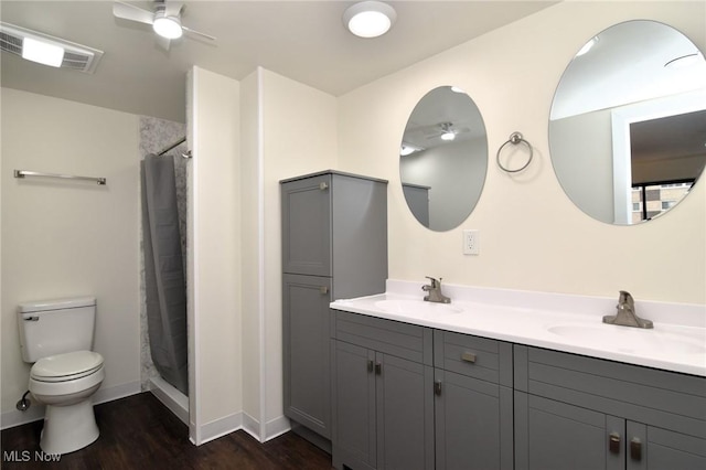 bathroom featuring a shower with curtain, toilet, wood-type flooring, and vanity