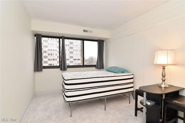 bedroom featuring light carpet