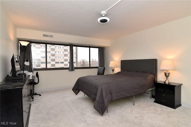 carpeted bedroom with a textured ceiling