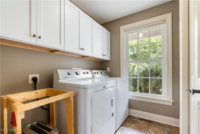 laundry area featuring cabinets and independent washer and dryer