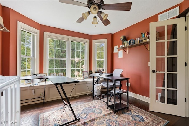 interior space with ceiling fan and dark wood-type flooring