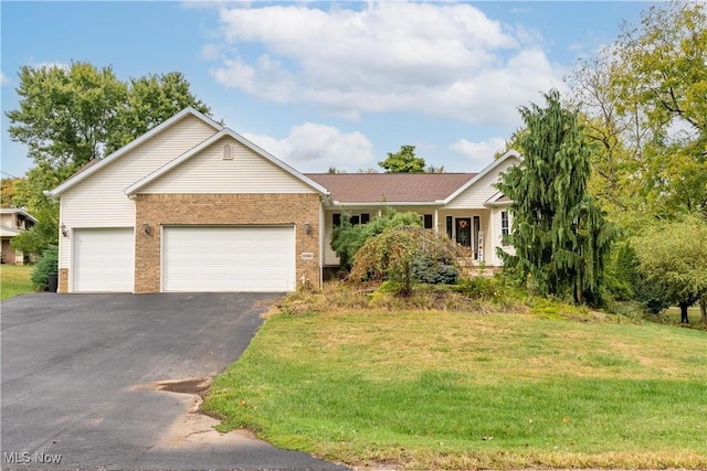 ranch-style home featuring a garage and a front yard