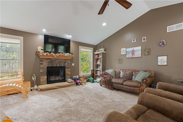 carpeted living room with ceiling fan, a fireplace, and lofted ceiling