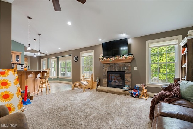 carpeted living room featuring a fireplace, ceiling fan, plenty of natural light, and lofted ceiling