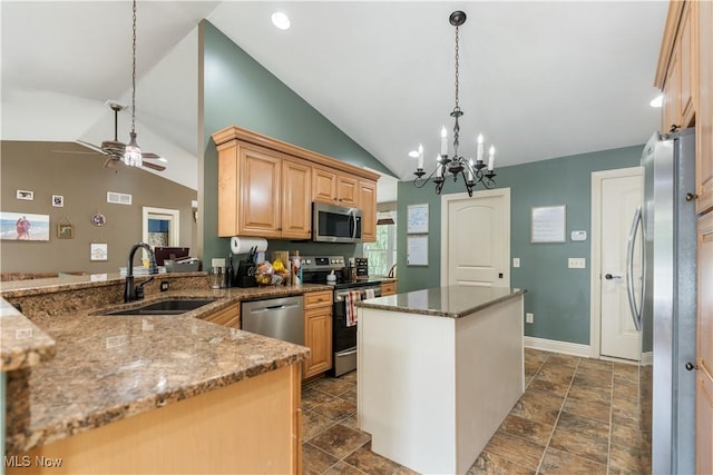 kitchen with ceiling fan with notable chandelier, sink, vaulted ceiling, light brown cabinetry, and stainless steel appliances