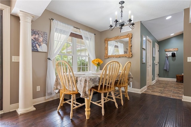 dining space featuring vaulted ceiling, ornate columns, dark hardwood / wood-style floors, and a notable chandelier