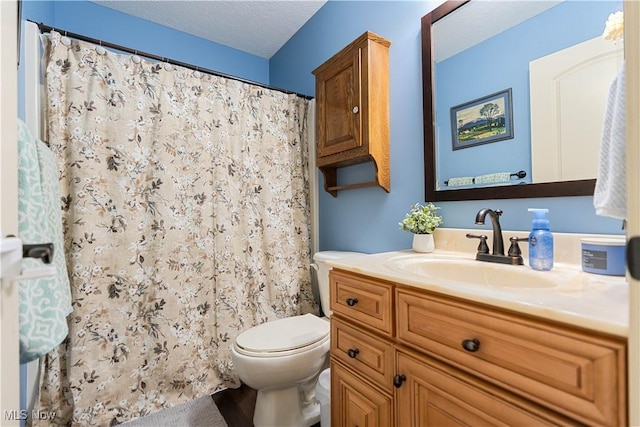 bathroom featuring vanity, a textured ceiling, toilet, and curtained shower