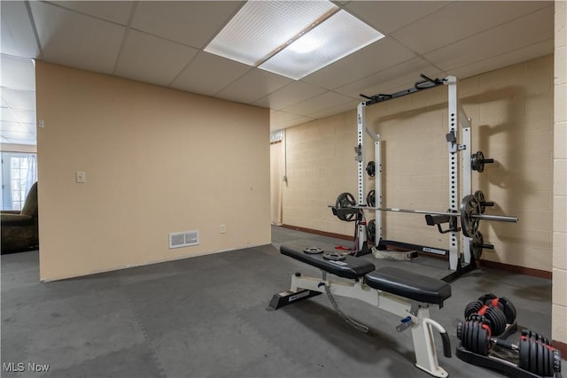 workout room with a paneled ceiling