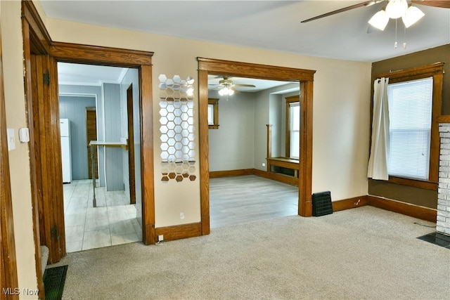 carpeted spare room with ceiling fan