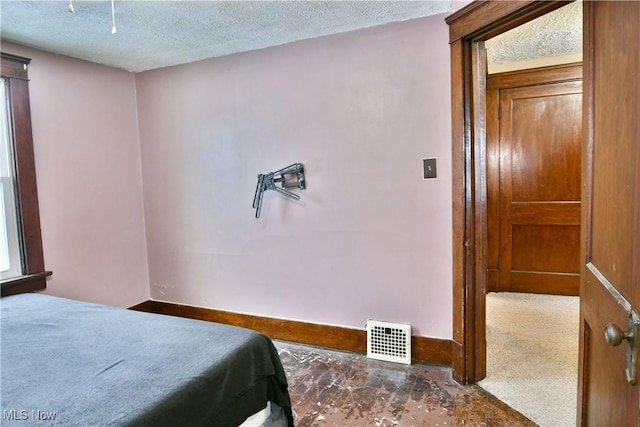 carpeted bedroom featuring a textured ceiling