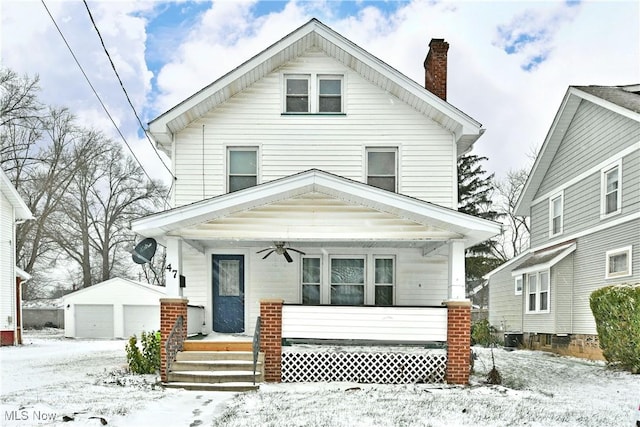 front facade with an outbuilding, a garage, and ceiling fan