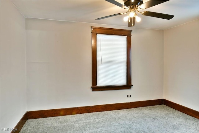 spare room featuring ceiling fan and carpet floors