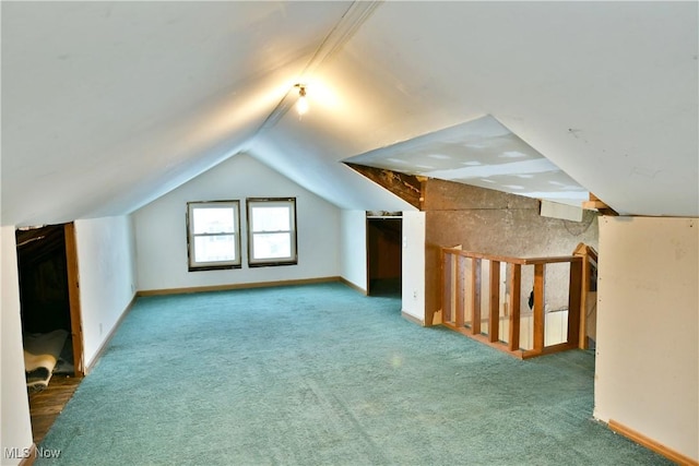 bonus room with carpet floors and lofted ceiling