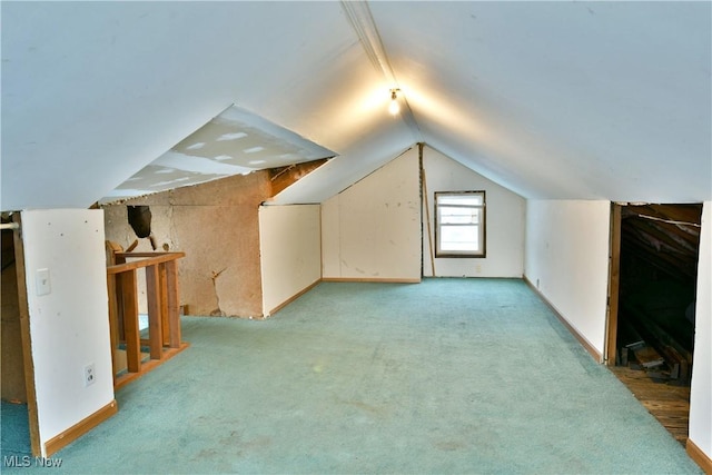 additional living space with light carpet and vaulted ceiling