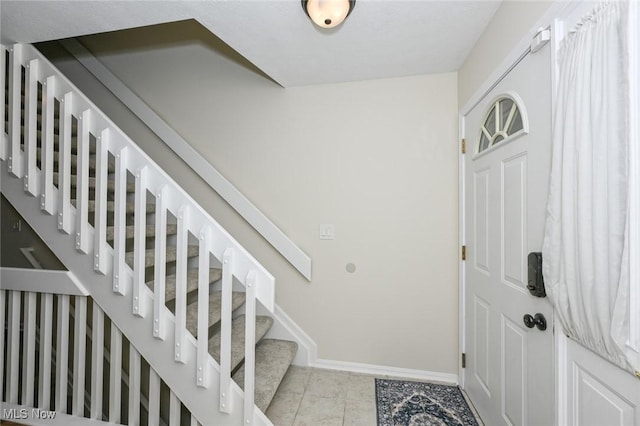 foyer entrance featuring light tile patterned floors