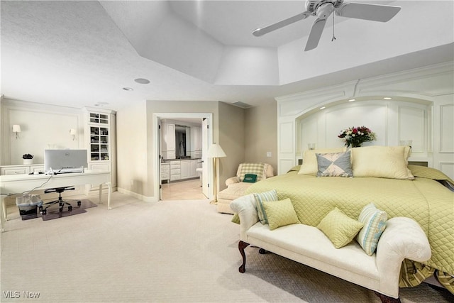 carpeted bedroom featuring ceiling fan and connected bathroom