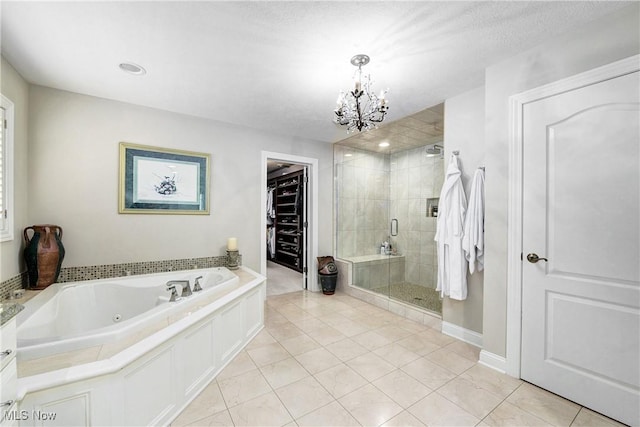 bathroom featuring tile patterned flooring, plus walk in shower, a textured ceiling, and an inviting chandelier