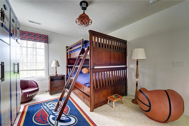 carpeted bedroom with a textured ceiling