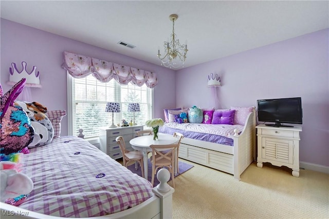 carpeted bedroom featuring a notable chandelier