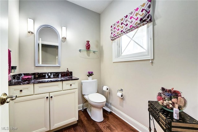 bathroom with hardwood / wood-style floors, vanity, and toilet