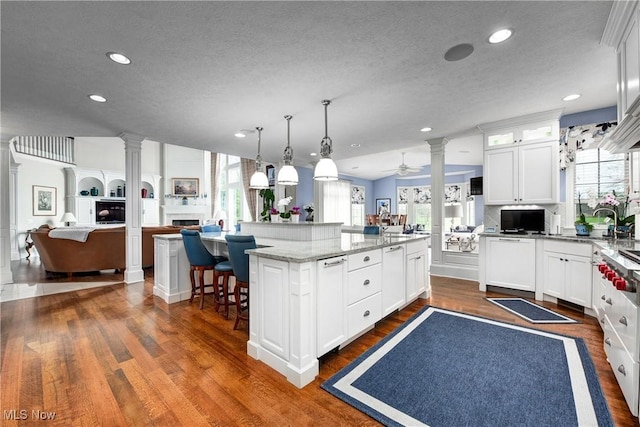 kitchen with a textured ceiling, a kitchen island, and plenty of natural light