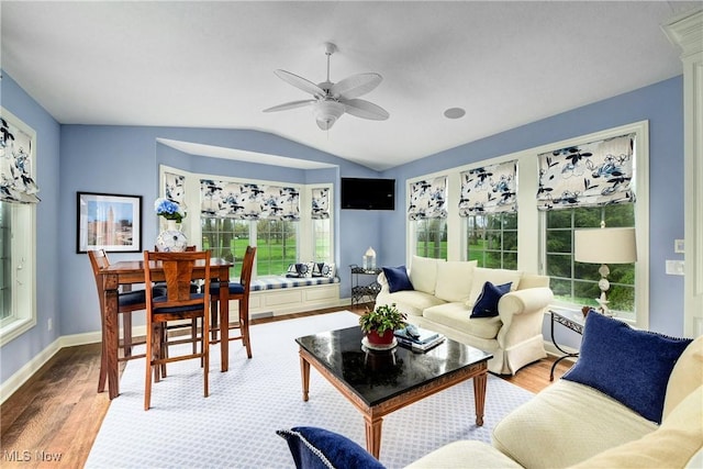 living room featuring plenty of natural light, ceiling fan, lofted ceiling, and light hardwood / wood-style flooring