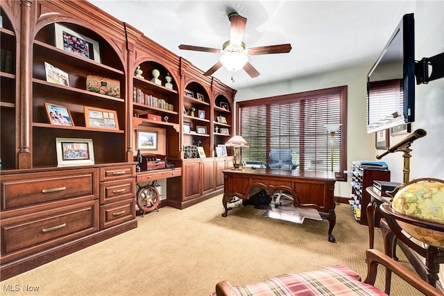 office space featuring ceiling fan and light carpet