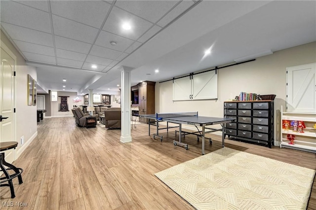 rec room featuring a drop ceiling and light wood-type flooring