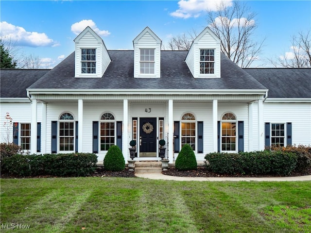 cape cod house featuring covered porch and a front yard