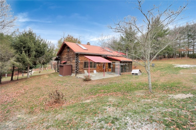 view of home's exterior with a yard and a patio area