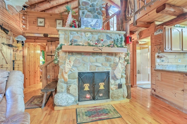 living room featuring wooden walls, wooden ceiling, and light hardwood / wood-style floors