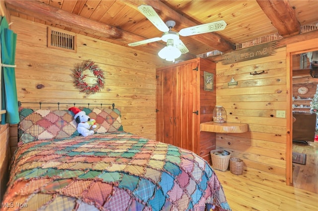 bedroom featuring beamed ceiling, ceiling fan, wood ceiling, and hardwood / wood-style flooring