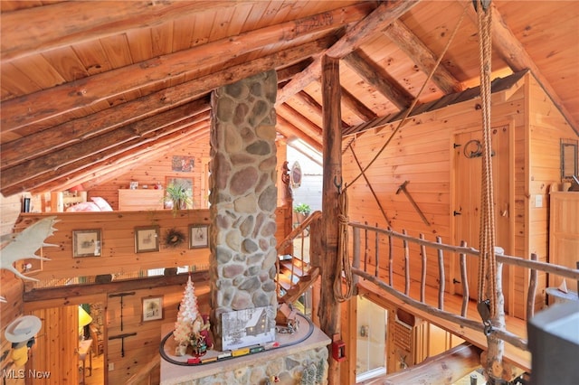 interior space with beam ceiling, wood ceiling, and wood walls