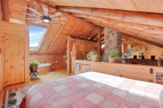 unfurnished bedroom featuring hardwood / wood-style floors, vaulted ceiling with skylight, and wood walls