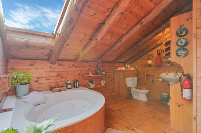 bathroom with hardwood / wood-style floors, wood walls, vaulted ceiling with skylight, toilet, and wood ceiling