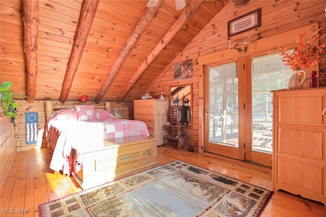 unfurnished bedroom with wooden ceiling, vaulted ceiling with beams, light hardwood / wood-style floors, and wooden walls