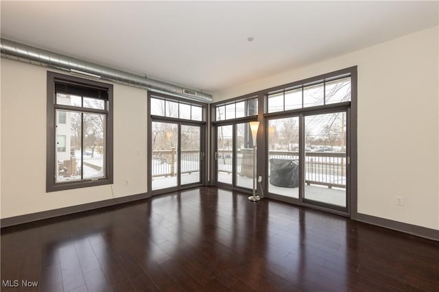 empty room with dark hardwood / wood-style floors