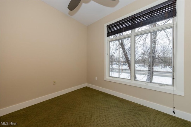 carpeted spare room featuring ceiling fan