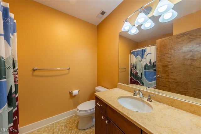 bathroom with tile patterned flooring, vanity, and toilet