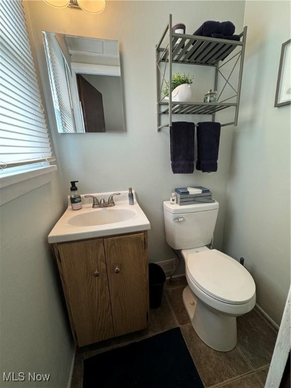 bathroom with tile patterned floors, vanity, and toilet