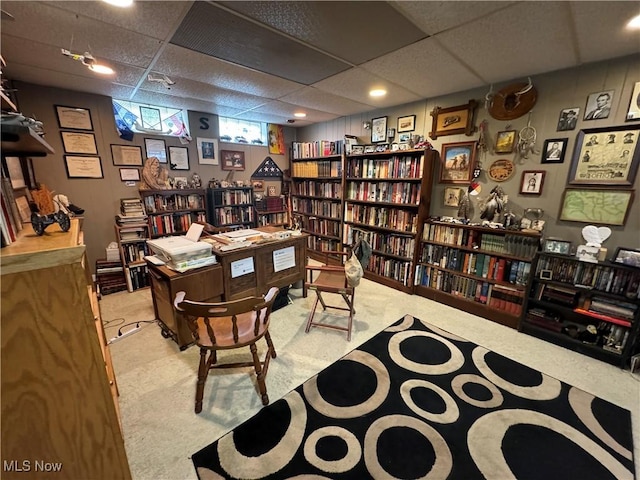 office area with a paneled ceiling and light carpet