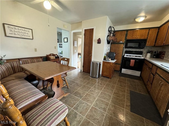 kitchen featuring decorative backsplash, ceiling fan, and white range with gas stovetop