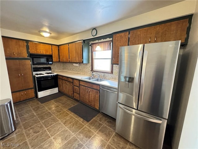 kitchen featuring decorative backsplash, sink, and stainless steel appliances