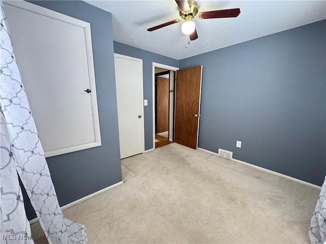 unfurnished bedroom with ceiling fan and light carpet