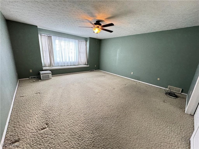 spare room with ceiling fan, carpet floors, and a textured ceiling