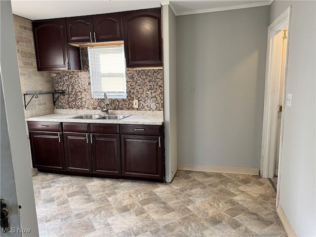 kitchen with tasteful backsplash, dark brown cabinetry, sink, and ornamental molding