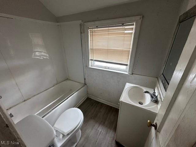 full bathroom with vanity, lofted ceiling, bathing tub / shower combination, hardwood / wood-style flooring, and toilet