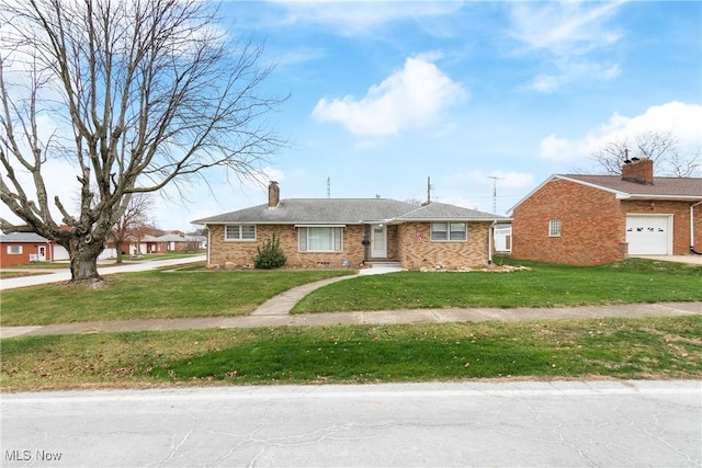 view of front facade featuring a front yard and a garage